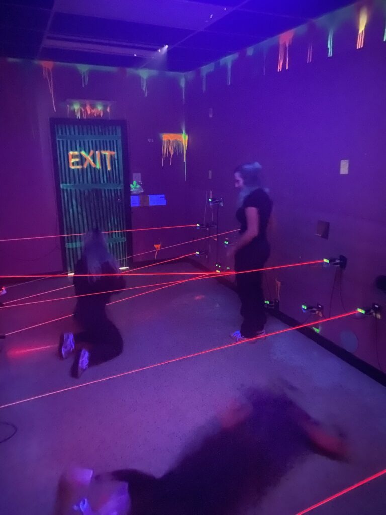 Player stepping through red laser beams in the Beat The Beams maze